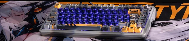 HITM keyboard with purple backlighting and orange accents on a character-illustrated mousepad