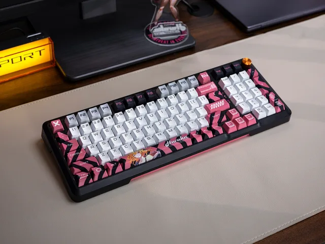 Haruka original keyboard photographed on a desk with its pink, white and black keycap design